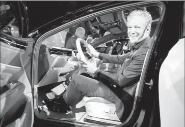  ?? Photograph­s by Damian Dovarganes Associated Press ?? SCOTT KEOGH, CEO of Volkswagen Group of America, sits behind the wheel of an I.D. Space Vizzion electric concept wagon with zero emissions last week at the Petersen Automotive Museum in Los Angeles.