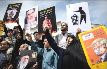  ??  ?? Iranians shout slogans during a protest against Trump’s decision to walk out of a 2015 nuclear deal, in Tehran, Iran. — Reuters photo