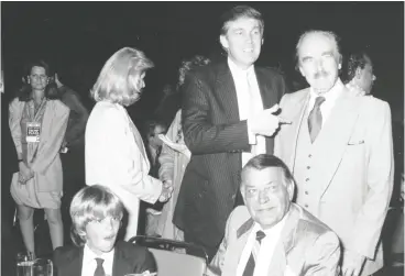  ?? TIME LIFE PICTURES / DMI / THE LIFE PICTURE COLLECTION VIA GETTY IMAGES ?? Donald Trump, centre, in 1988 with his wife at the time, Ivana, and young son Donald Jr., chats with his father Fred Trump at a Mike Tyson-michael Spinks pre-fight party.