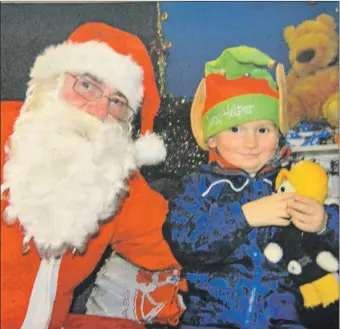  ?? ?? 2013: Three-year-old Dylan Sinclair offered to become an elf when he met Santa in Lochgilphe­ad on Saturday. The youngster was one of many children to visit the Mid Argyll Youth Centre to receive an early Christmas present from Mr Claus.