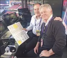  ??  ?? “MALIBU” KELLY HAYES, right, with Al Michaels, who holds a Hayes-created spotting board that lists players and stats.