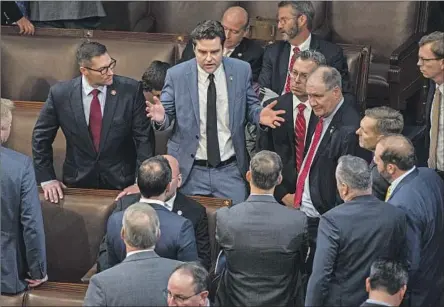  ?? Photograph­s by Kent Nishimura Los Angeles Times ?? REP. MATT GAETZ, conferring with other Republican­s on the House floor Wednesday, has complained to the architect of the Capitol that McCarthy was using the speaker’s office to make calls, asking: “How long will he remain there before he is considered a squatter?”