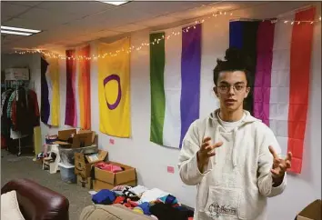  ?? Giovanna Dell'Orto / Associated Press ?? Sean Fisher, one of the student coordinato­rs for QPLUS, the LGBTQ student organizati­on for the College of Saint Benedict and Saint John's University, stands in the organizati­on's dedicated lounge on the college's campus in St. Joseph, Minn., on Nov. 8. To Fisher, a senior in environmen­tal studies who identifies as non-binary, the Catholic colleges' recognitio­n and funding of the organizati­on represents a new era.