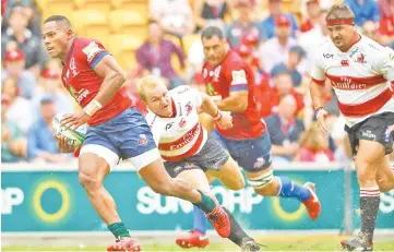  ??  ?? Reds’ Chris Feauai-Sautia (L) beats the tackle of Lions’ Dillon Smit during the Super Rugby match between Australia’s Queensland Reds and South Africa’s Golden Lions in Brisbane. - AFP photo