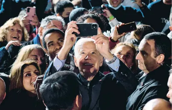  ?? NIaHOLAS KAMM / AFP ?? Joe Biden fent-se una selfie amb seguidors demòcrates en un acte electoral a Arligton, Virgínia