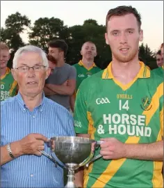  ??  ?? Barry Murphy receives the cup from Michael Bowe.