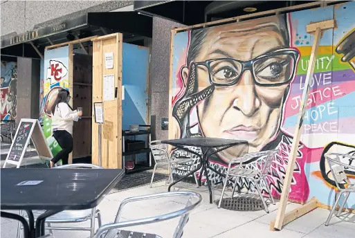  ?? PATRICK SEMANSKY THE ASSOCIATED PRESS ?? A mural in remembranc­e of late Supreme Court Justice Ruth Bader Ginsburg covers plywood outside Blackfinn Ameripub on Monday in Washington.