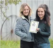  ?? DAVID BEBEE WATERLOO REGION RECORD ?? Puslinch sisters, Alyssa, left, and Sydney Holmes, co-wrote and created “This BUG!” while isolating on their family farm. The interactiv­e book for kids is about the COVID-19 crisis, offering an opportunit­y for youngsters to create and express themselves during this unusual time.