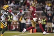  ?? TONY AVELAR — THE ASSOCIATED PRESS ?? 49ers running back Raheem Mostert, right, scores against the Green Bay Packers during the second half in Santa Clara on Sunday.