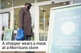  ??  ?? A shopper wears a mask at a Morrisons store