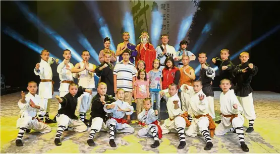  ??  ?? (Front row, standing, fifth from left) Bryan, Athena, Amelia, Xiang Lin and Gabrielle Ann posing with the star performers who are trained in Shaolin kung fu.