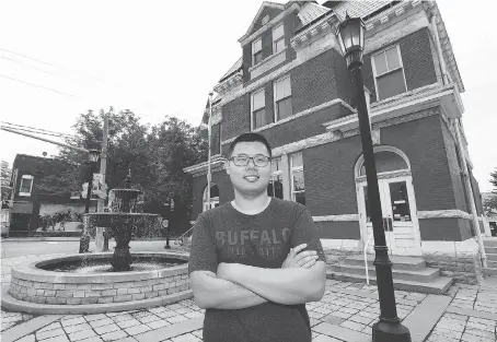  ?? PHOTOS: DAN JANISSE ?? Matt Zhao of UCRez Property Management stands in front of the former Sandwich post office Wednesday. The site will soon reopen as the Post Cafe. Zhao’s company has purchased other properties nearby in hopes of building new student housing.