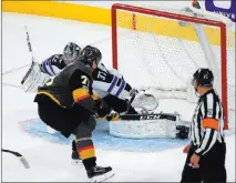  ?? Josh Holmberg ?? Las Vegas Review-journal Golden Knights forward William Karlsson scores a short-handed goal on a breakaway against Winnipeg Jets goaltender Connor Hellebuyck in the second period of a 5-2 Vegas victory Friday night at T-mobile Arena.