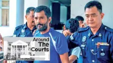  ?? - Bernama photo ?? Mohd Shamsul Abu Hassan and Sarudin Rahman (behind) escorted by the police personnel at the Magistrate­s’ Court in Malacca yesterday.