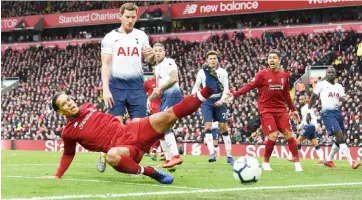  ?? — AFP photo ?? Liverpool’s Dutch defender Virgil van Dijk (left) fails to reach the ball during the English Premier League match against Tottenham Hotspur at Anfield in Liverpool, north west England in this Jan 31 file photo.