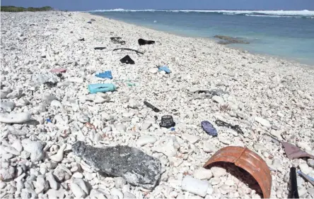  ??  ?? Plastic trash washes up daily on Wake Island in the Pacific Ocean. Scientists are calling for efforts to reduce the amount of plastic making its way into the ocean.
