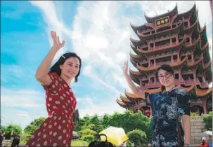  ?? XIAO YIJIU / XINHUA ?? Visitors enjoy the springtime at the Yellow Crane Tower, a popular tourist attraction in Wuhan, Hubei province. Local residents are gradually recovering from the losses caused by the pandemic.