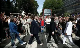  ?? Photograph: Henry Nicholls/Reuters ?? The Fab Four stop traffic on Abbey Road to recreate the Beatles cover shot