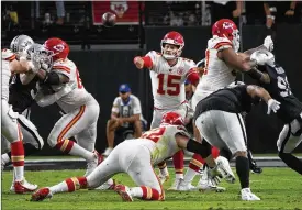  ?? RICK SCUTERI / ASSOCIATED PRESS ?? Kansas City Chiefs quarterbac­k Patrick Mahomes threw for 406 yards and five touchdowns without an intercepti­on, and the Chiefs piled up 516 yards, during a 41-14 romp over the Las Vegas Raiders on Sunday night.