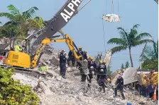  ?? LYNNE SLADKY/ASSOCIATED PRESS ?? Rescue crews work Monday at the site of the collapsed Champlain Towers condo building after the remaining structure was demolished Sunday, in Surfside, Fla.