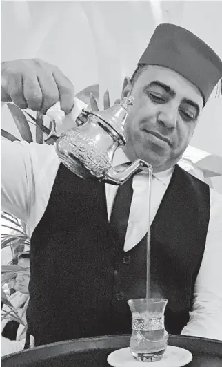  ?? FRANCOISE DROGIN/LOS ANGELES TIMES ?? A waiter pours sweet mint tea after dinner at Rick's Cafe in Casablanca.