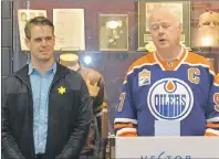  ?? ROBERT CROSSLEY/THE GUARDIAN ?? Connor McDavid’s great-uncle, Ernie MacAulay, right, wears his greatnephe­w’s jersey at the Faceoff Against Cancer launch event. He is joined by Ben Parsons, chairman of Faceoff Against Cancer and a Canadian Cancer Society board member.