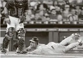  ?? Michael Ciaglo / Houston Chronicle ?? The Athletics’ Boog Powell, who shares a nickname with the former Orioles slugger, gets down and dirty against the Astros on Sunday.