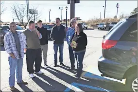  ?? / Contribute­d ?? The group of local business owners and profession­als present Ginger Miller (right) with a new handicapac­cessible van for her son Will Miller, who has cerebral palsy and cystic fibrosis.