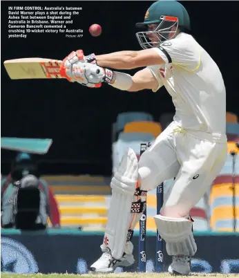  ?? Picture: AFP ?? IN FIRM CONTROL: Australia’s batsmen David Warner plays a shot during the Ashes Test between England and Australia in Brisbane. Warner and Cameron Bancroft cemented a crushing 10-wicket victory for Australia yesterday