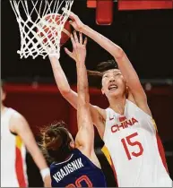  ?? Charlie Neibergall / Associated Press ?? China’s Han Xu (15) shoots over Serbia’s Tina Krajisnik during a quarterfin­al game at the 2020 Summer Olympics in 2021 in Saitama, Japan.