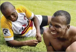  ?? COURTESY OF LINDSAY MYENI VIA AP ?? In this undated photo, former pro soccer player Lindani Myeni (foreground, shirtless) rests after a rugby match in Eshowe, South Africa. The finding that Myeni suffered from a degenerati­ve brain disease often found in American football players could explain his behavior on the day he died.