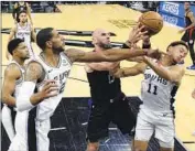  ?? Eric Gay Associated Press ?? MARCIN GORTAT battles San Antonio’s LaMarcus Aldridge, left, and Bryn Forbes during Spurs’ rout.