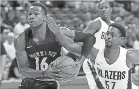  ??  ?? The Grizzlies' Brandon Goodwin, left, drives around the Trail Blazers' Casper Ware Jr. during a Summer League game July 16. JOHN LOCHER / AP