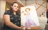  ?? Christian Abraham / Hearst Connecticu­t Media ?? Christy Pugh poses with a photo of her daughter Emma at her home in Southbury on Tuesday. Sixyearold Emma, who attended Columbus Elementary in Norwalk died last fall of the flu. Christy is working to spread flu education and awareness.