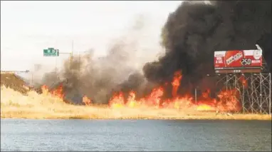  ?? Chris Velardi / WTNH News 8 ?? A large brush fire covered Interstate 91 north near exit 8 in 2012.