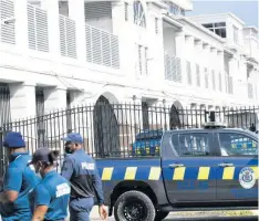  ?? RUDOLPH BROWN ?? Police outside the Home Circuit Court in downtown Kingston where the alleged members of the Clansman gang are being tried.