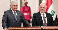  ?? — AFP ?? BAGHDAD: Turkish Prime Minister Binali Yildirim (left) and Iraqi Prime Minister Haider Al-Abadi hold a joint press conference after the Turkey-Iraq High Level Strategic Cooperatio­n Council meeting at the government­al palace yesterday.