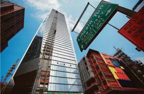  ?? Bloomberg ?? 10 Hudson Yards (centre), home to Coach Inc.’s new offices, stands in New York. With banking regulators warning of a potential real estate bubble, firms such as Blackstone Group LP and Starwood Property Trust Inc. stand to become an even larger force...