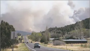  ?? ?? State Police went door to door in the Holman area to notify residents of a mandatory evacuation order Sunday (May 1) as strong winds pushed the Hermits Peak-Calf Canyon fire toward the Mora Valley.