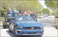  ??  ?? Williams’ teacher Andrea Jenkins drives a Mustang on loan for the teacher parade by the Farmington elementary school on Thursday afternoon. Teachers, paraprofes­sionals, administra­tors and nutrition staff greeted students throughout the district during the parade that lasted about two hours.