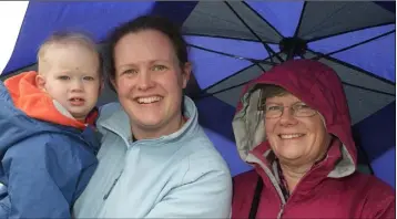 ??  ?? Lisa-Ann Parle with her son, Ciaran, and mother, Michelle Dempsey, keeping dry.