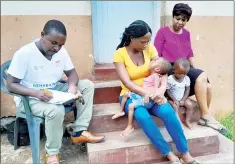  ?? ?? Sthembile Motsa in the centre carrying her child flanked by Cheshire Homes Director Dlamini (R) and Rehabilita­tion Technician Ndebele.