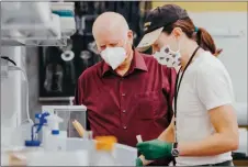  ?? ?? PHOTO: Dr. Robert Sutherland, shown on the left, and his lab will determine the dose range of active ingredient­s that will be used in human trials and will identify potential side effects.