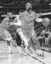  ?? David Zalubowski / Associated Press ?? Houston guard Chris Paul, front, drives to the basket as forward PJ Tucker, back left, blocks Denver guard Jamal Murray. Paul had 21 points.