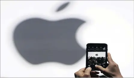  ?? PHOTO: AP ?? Apple’s latest fiscal and sales results show that the company is riding on a crest of success. Surprising strong third-quarter earnings drove the company’s share price to an all-time high on the New York Stock Exchange yesterday.
