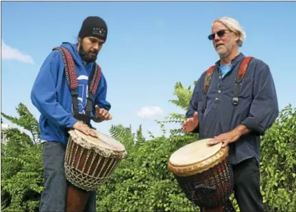  ?? CASSANDRA DAY — HEARST CONNECTICU­T MEDIA ?? Drummers Andrew Mark Prue of East Granby and Craig Norton of Middletown play djembes Wednesday morning at Harbor Park on the Connecticu­t River.