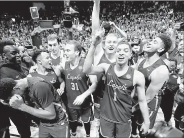  ?? Kevin C. Cox Getty Images ?? IN THE MIDDLE of the Loyola Chicago celebratio­n after reaching the Final Four is Dylan Boehm (31), who pretty much talked his way onto the Ramblers’ roster and didn’t score a point during his freshman season.