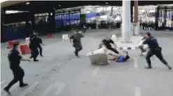  ?? — AFP ?? This image grab taken from handout video footage released yesterday by the Spanish Police shows Spanish Police apprehendi­ng a man armed with a knife at the Beni Anzar border crossing between Morocco and the Spanish territory of Melilla.