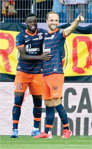  ?? Agence France-presse ?? Montpellie­r’s Stephy Mavididi (left) celebrates with teammates after scoring a goal against Lens during their French League match.