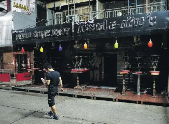  ?? — GETTY IMAGES ?? The normally boisterous clubs and bars of Bangkok’s adult entertainm­ent district, Soi Cowboy, remain shuttered and silent as Thailand continues to officially mourn the loss of King Bhumibol Adulyadej last week after 70 years on the throne.